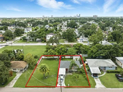 an aerial view of a residential houses with outdoor space and street view