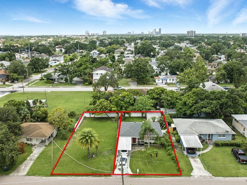 an aerial view of a residential houses with outdoor space and street view