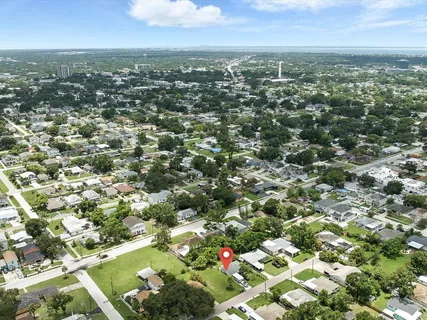 an aerial view of residential houses with city view