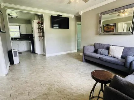 a kitchen with stainless steel appliances a stove a sink a microwave a refrigerator and cabinets