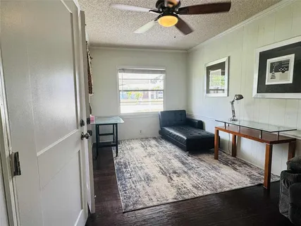 a bedroom with a bed and a flat tv screen on the dresser