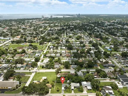 an aerial view of residential houses with city view