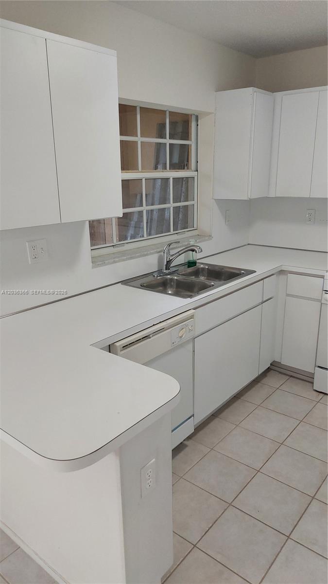 7083 Southwest 158th Court Miami, FL 33193 - Photo 9 of 22 a kitchen with a sink and cabinets