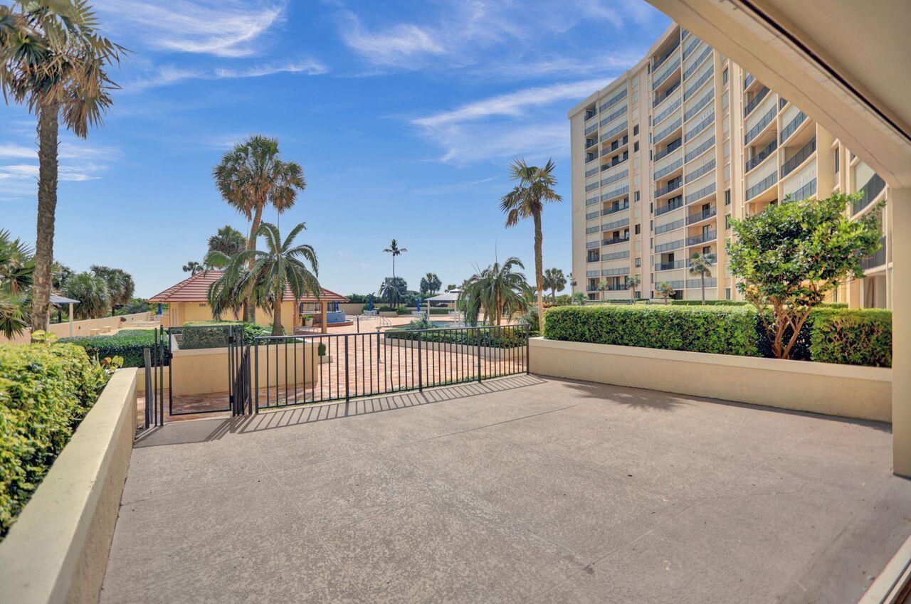 100 Ocean Trail Way, Unit 109 Jupiter, FL 33477 - Photo 11 of 27 a view of a building and bench next to road