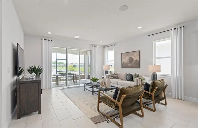 a living room with furniture and a large window