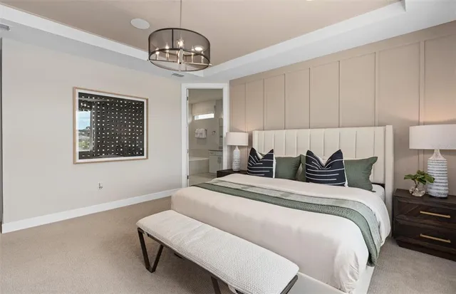 a spacious bedroom with a bed dresser and a window