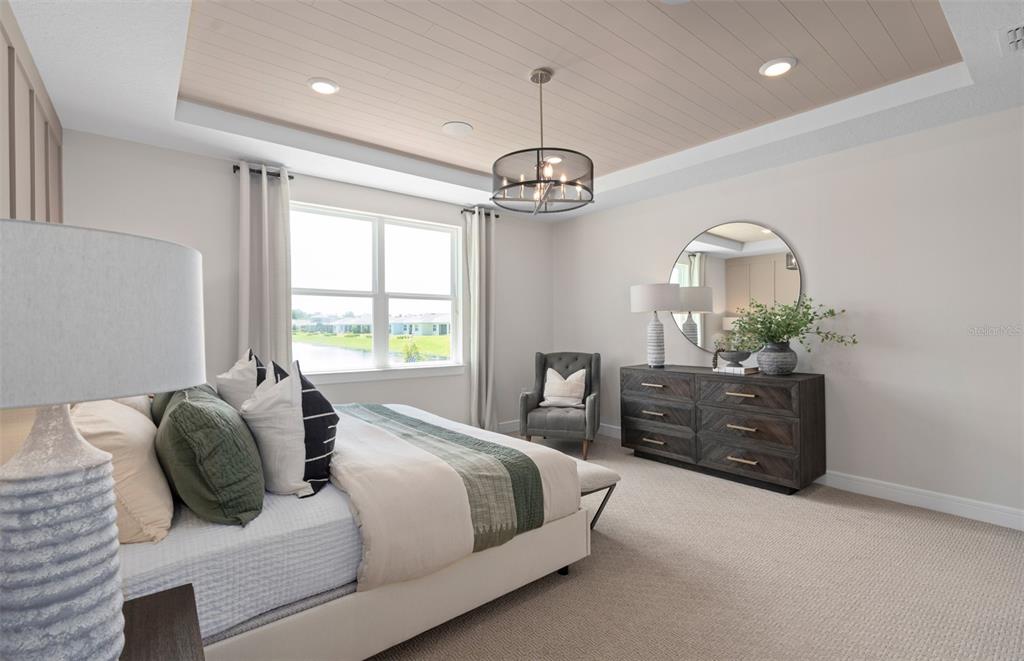 6249 Dew Drop Loop St. Cloud, FL 34771 - Photo 17 of 26 a spacious bedroom with a bed dresser and a window