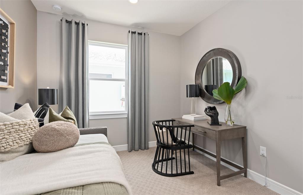 6249 Dew Drop Loop St. Cloud, FL 34771 - Photo 24 of 26 a bedroom with a bed and a table