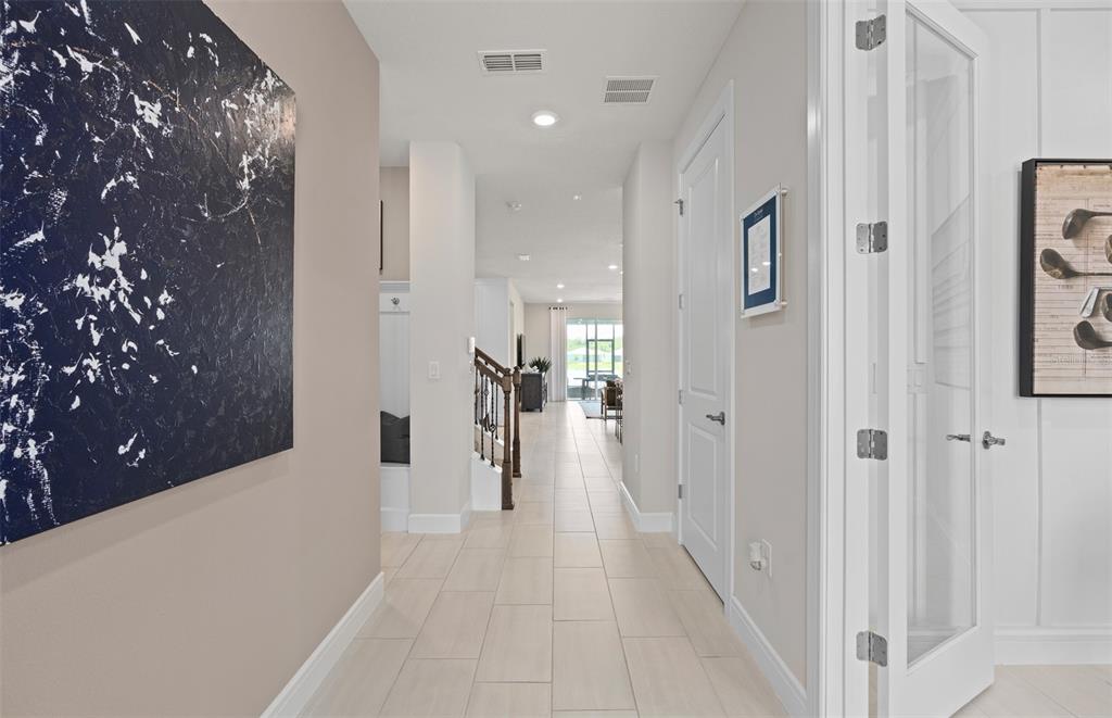 6249 Dew Drop Loop St. Cloud, FL 34771 - Photo 3 of 26 a view of a hallway with a chandelier and entryway