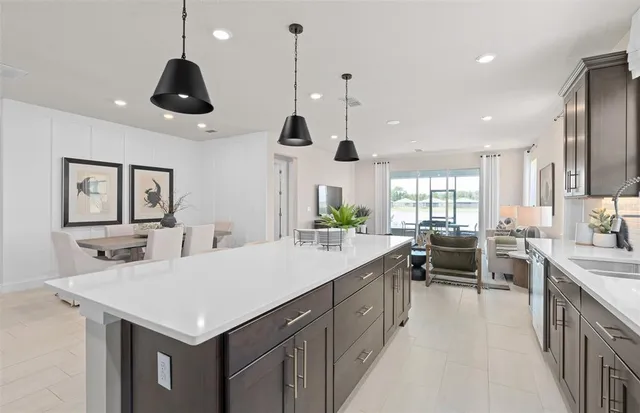 a kitchen with stainless steel appliances kitchen island granite countertop a stove a sink and a refrigerator