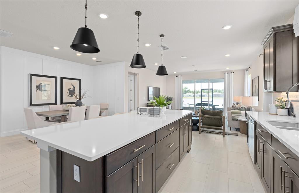 6249 Dew Drop Loop St. Cloud, FL 34771 - Photo 9 of 26 a large kitchen with a counter space a sink appliances and a large window