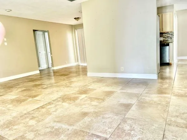 a view of a livingroom with wooden floor and a bathroom