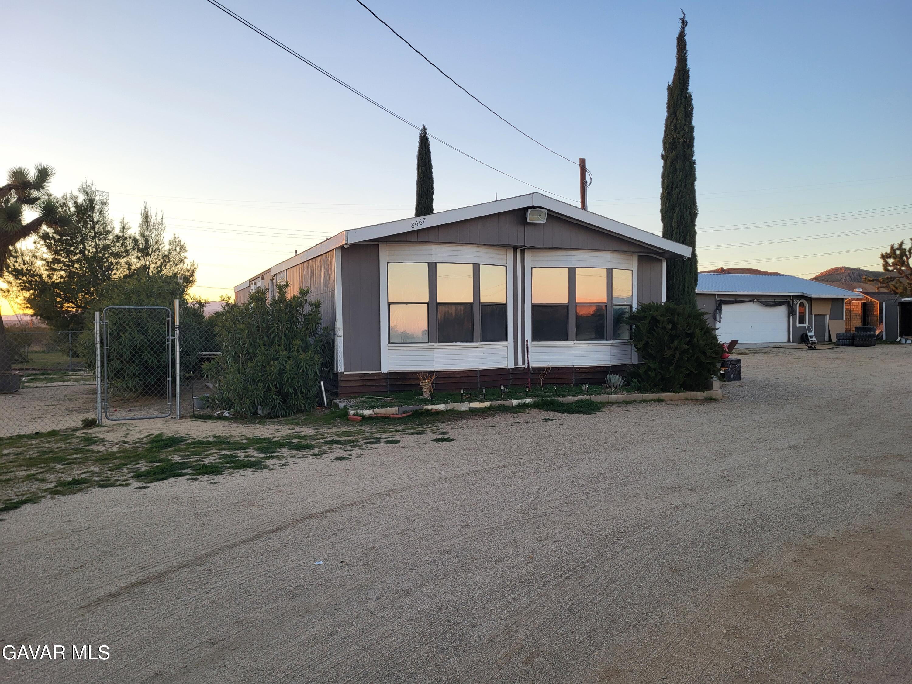 8667 70th Street West Mojave, CA 93501 - Photo 31 of 32 a front view of a house with a yard