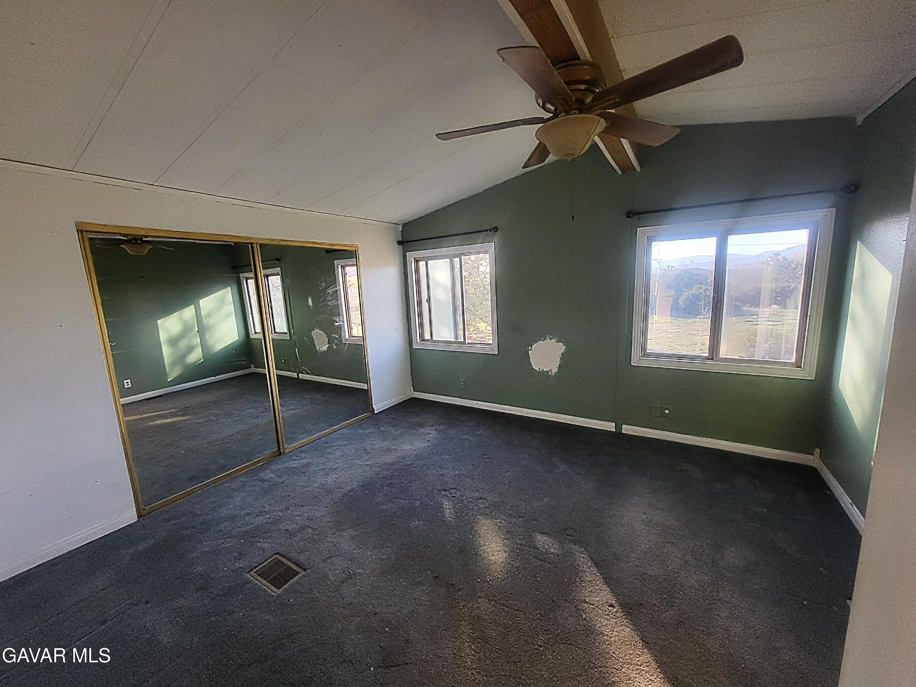 8667 70th Street West Mojave, CA 93501 - Photo 8 of 32 an empty room with windows and fan