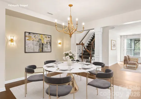 a living room with furniture and floor to ceiling windows with wooden floor
