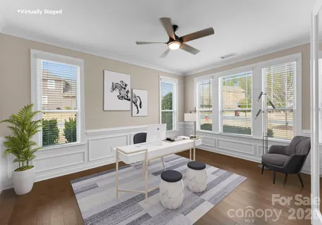 a bedroom with a large bed and a ceiling fan