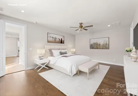 a bedroom with a large bed and a flat screen tv