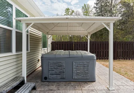 a front view of house with yard and trees around