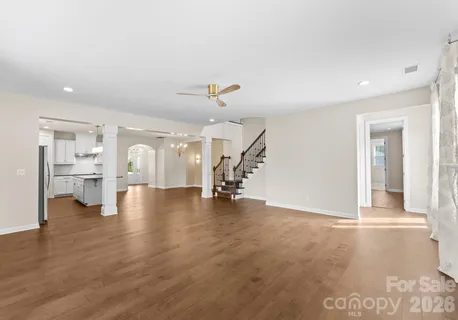 an empty room with windows and fireplace