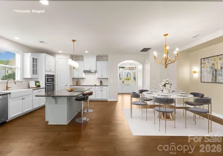 a kitchen with stainless steel appliances granite countertop a sink a stove and a refrigerator