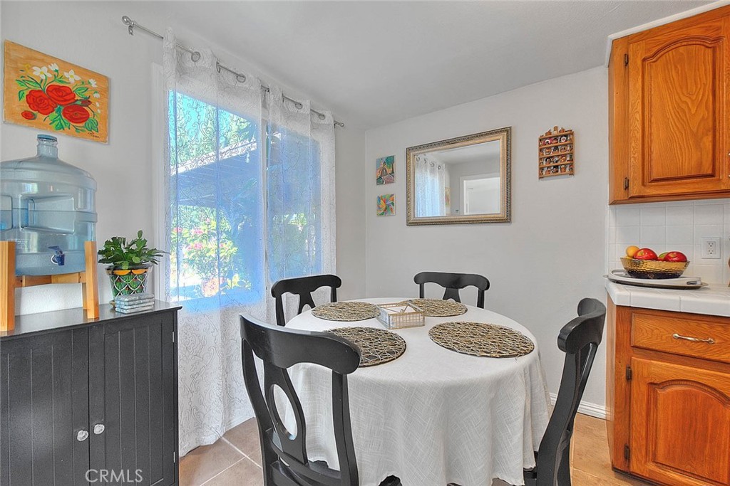 17860 East Laxford Road Azusa, CA 91702 - Photo 11 of 52 a dining room with furniture a potted plant and a large window
