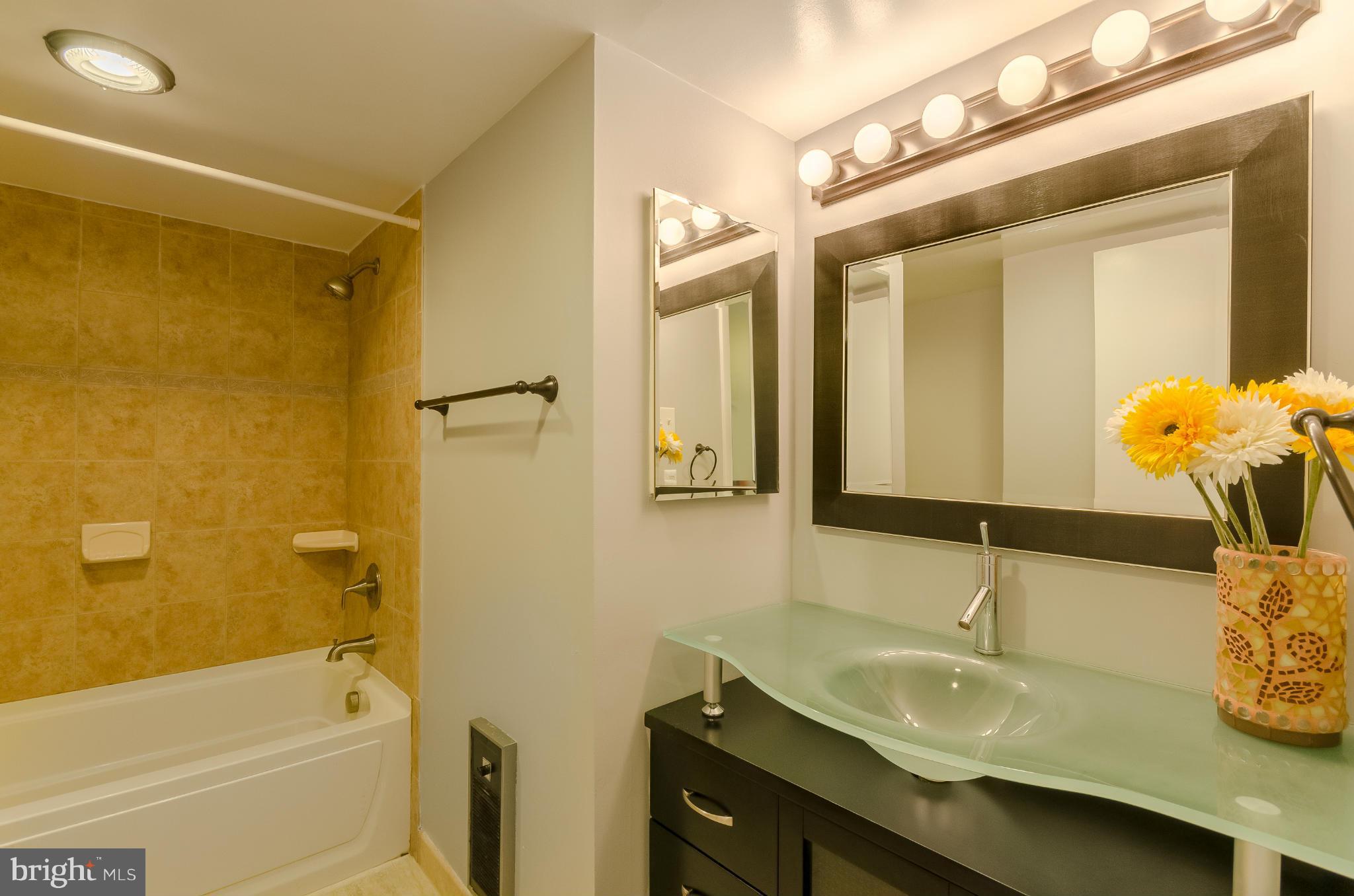 1245 13th Street Northwest, Unit 101 Washington, DC 20005 - Photo 11 of 25 a bathroom with a sink and a mirror