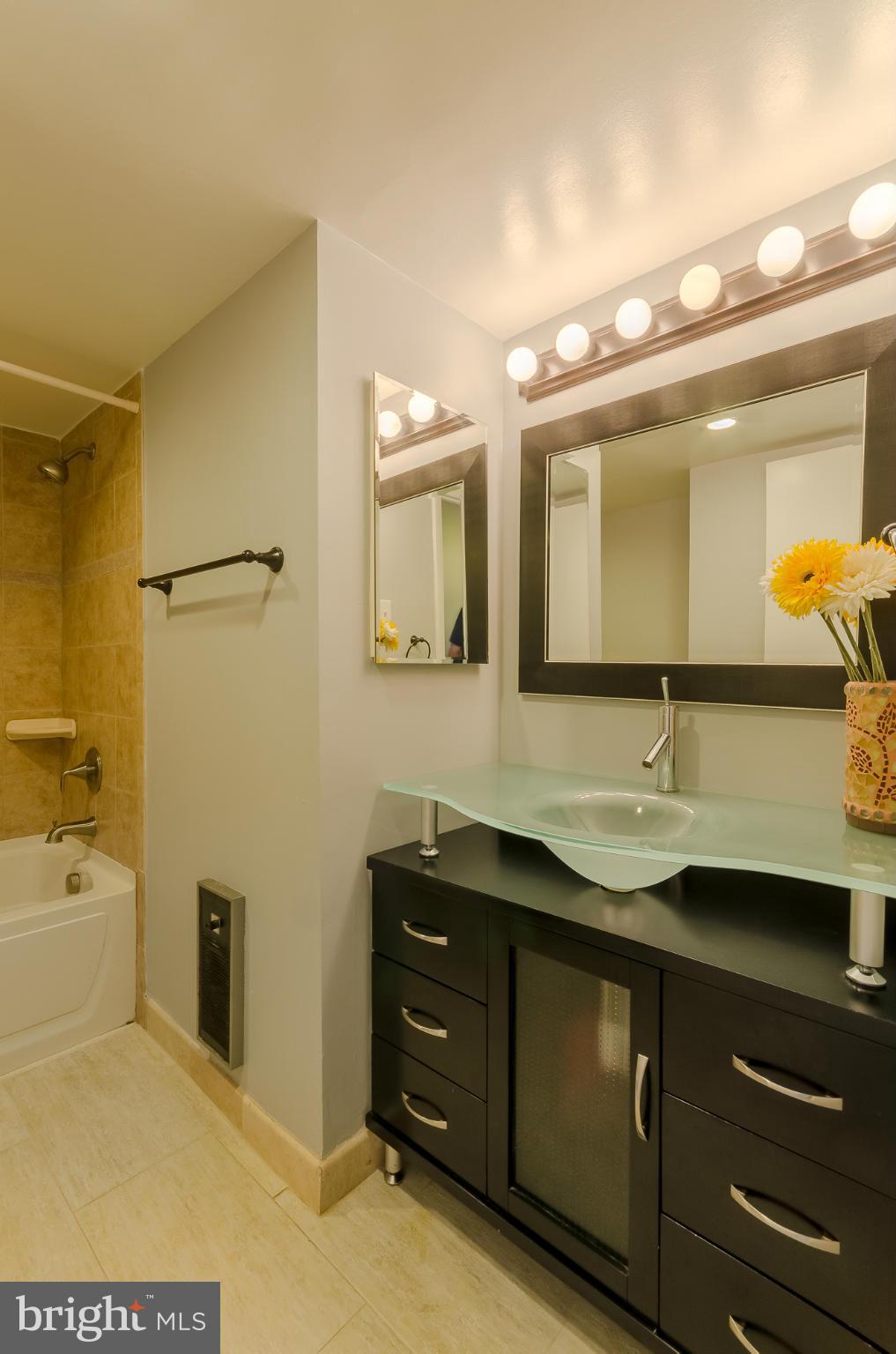 1245 13th Street Northwest, Unit 101 Washington, DC 20005 - Photo 12 of 25 a bathroom with a sink and a mirror