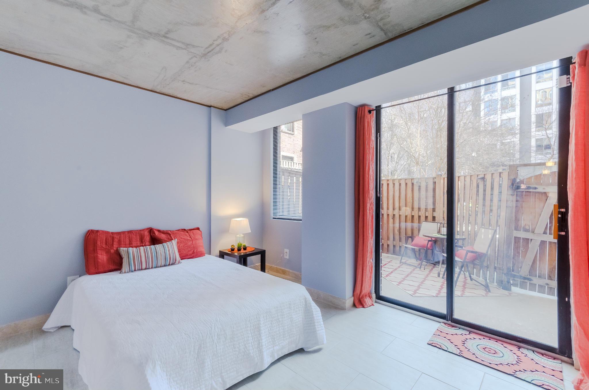 1245 13th Street Northwest, Unit 101 Washington, DC 20005 - Photo 13 of 25 a bedroom with a large bed and a large window