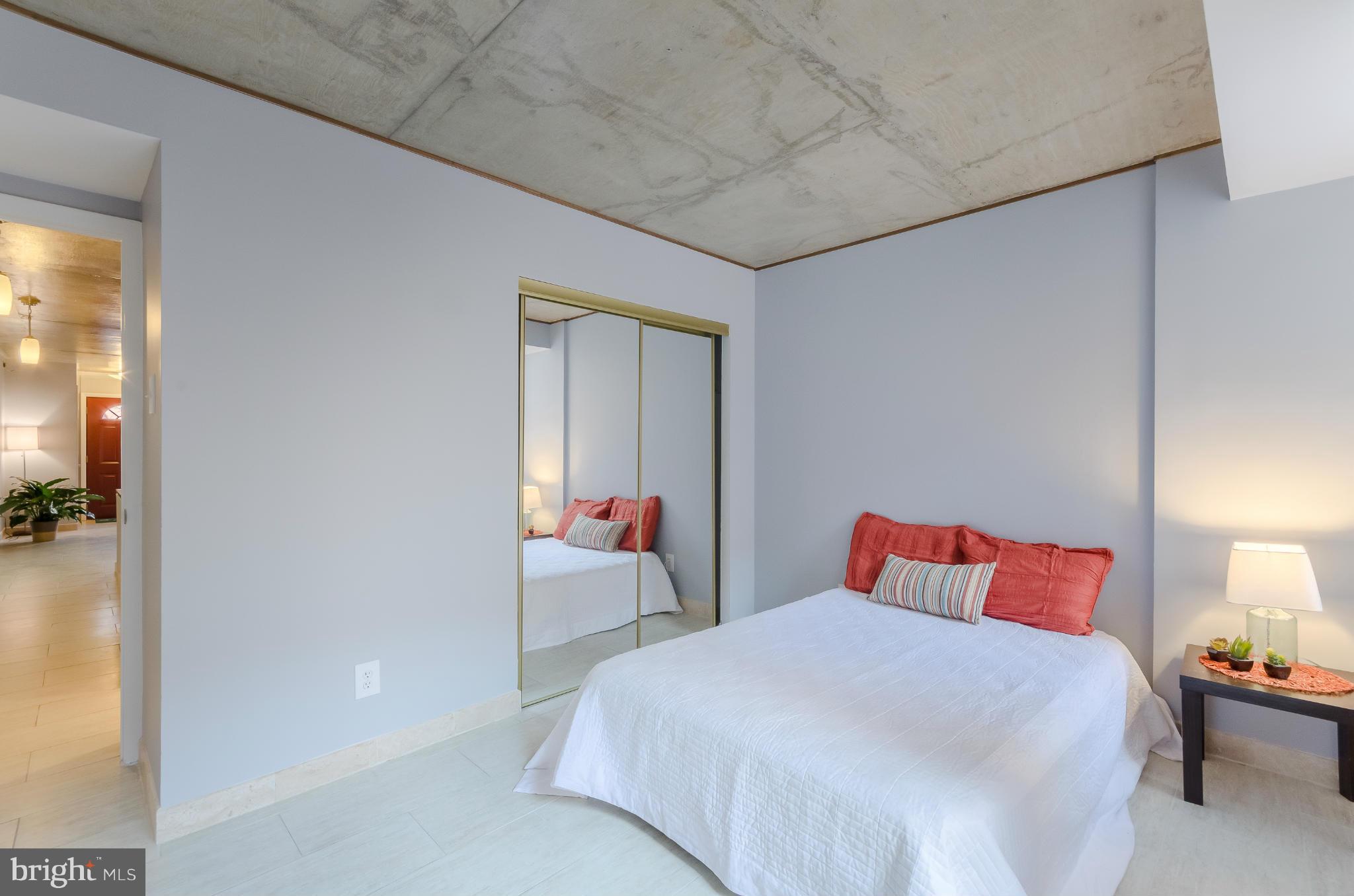 1245 13th Street Northwest, Unit 101 Washington, DC 20005 - Photo 15 of 25 a bedroom with bed and a night stand