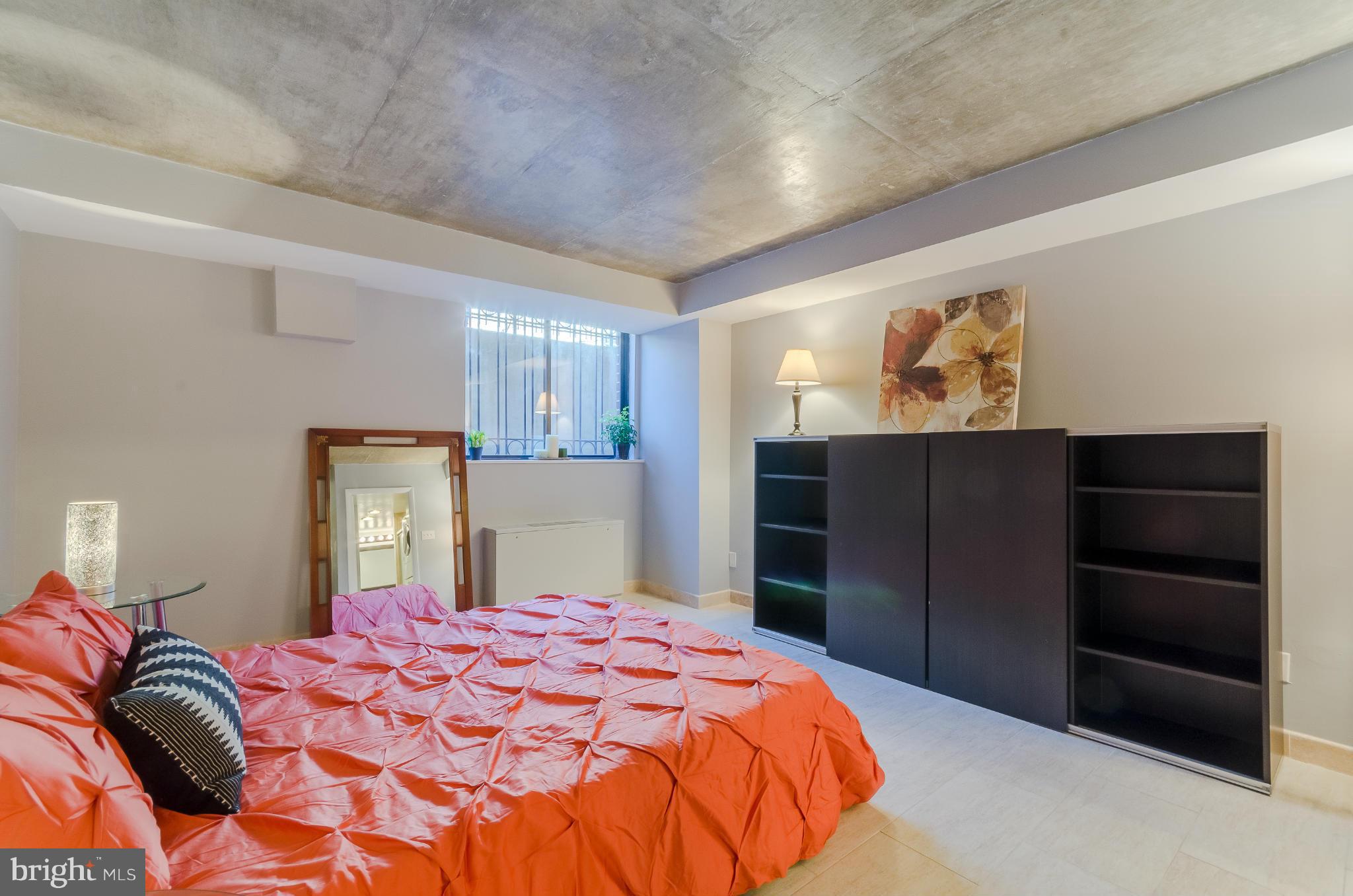 1245 13th Street Northwest, Unit 101 Washington, DC 20005 - Photo 20 of 25 a bedroom with a bed and a television