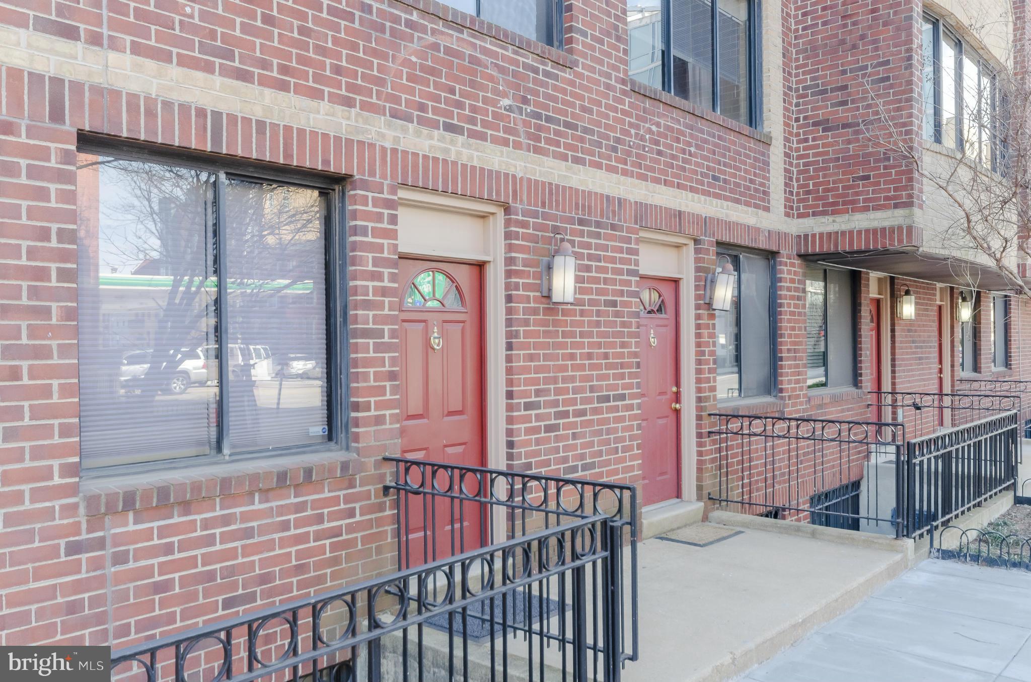1245 13th Street Northwest, Unit 101 Washington, DC 20005 - Photo 23 of 25 a view of a brick house with large windows