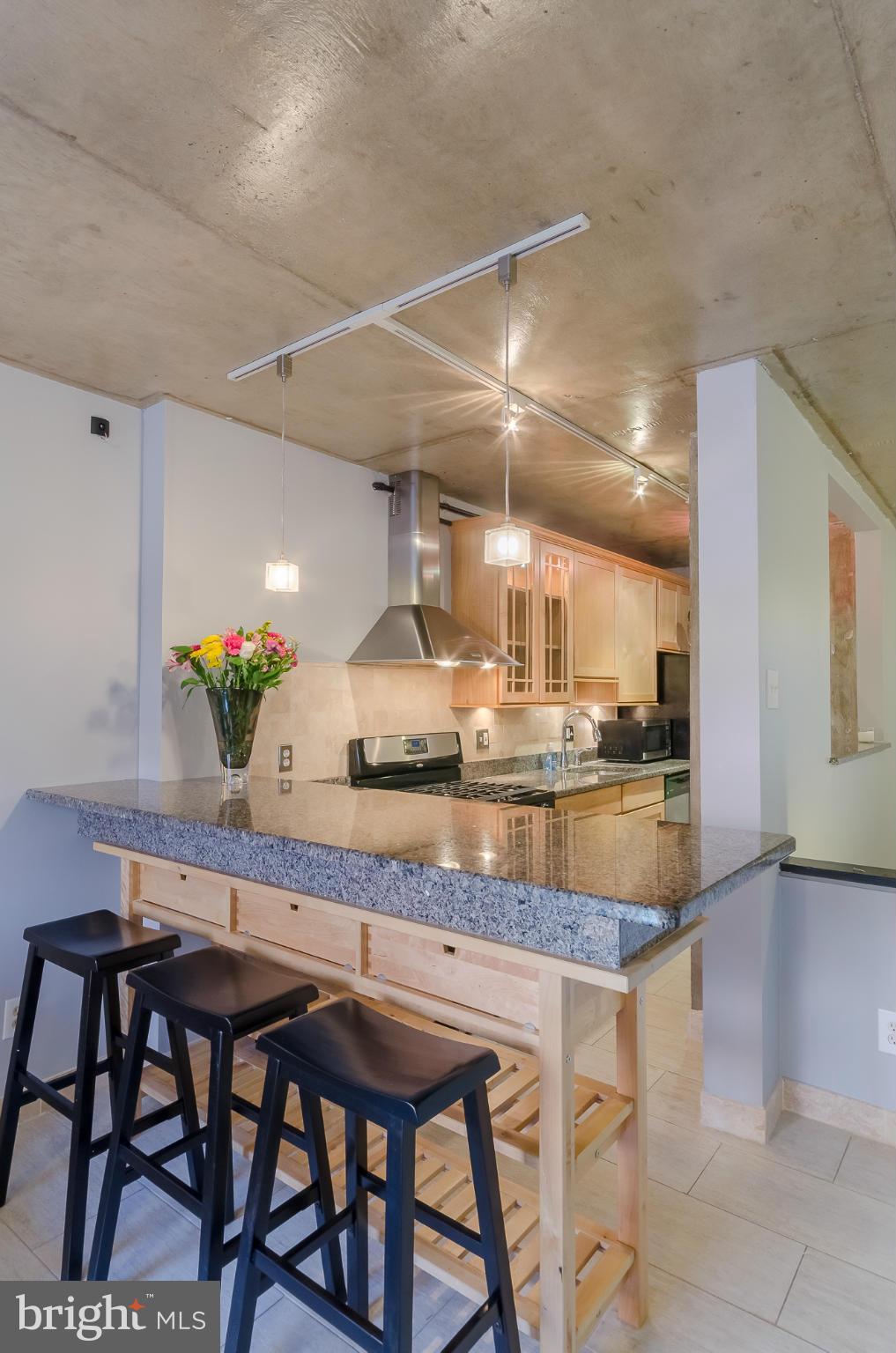 1245 13th Street Northwest, Unit 101 Washington, DC 20005 - Photo 6 of 25 a kitchen with granite countertop counter top space and chairs