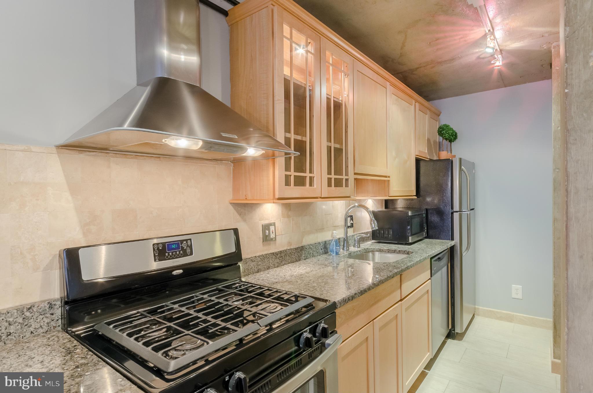1245 13th Street Northwest, Unit 101 Washington, DC 20005 - Photo 8 of 25 a kitchen with a stove and a sink