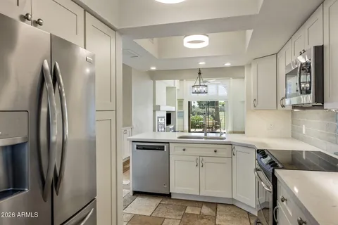 a kitchen with a sink stainless steel appliances and cabinets