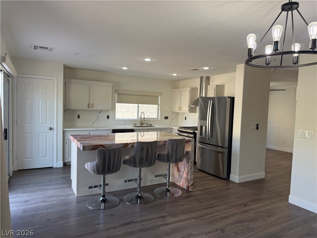 1141 Cathedral Ridge Street Henderson, NV 89052 - Photo 25 of 77 This sleek kitchen features an inviting island, perfect for casual dining and entertaining.