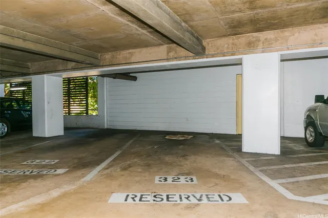 a living room with patio furniture and a potted plant