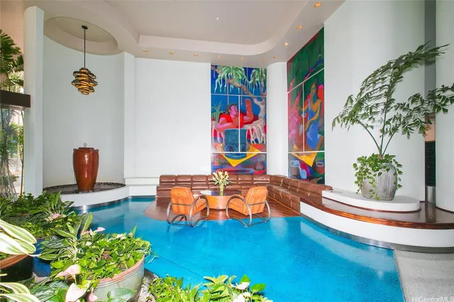 a swimming pool with outdoor seating and yard