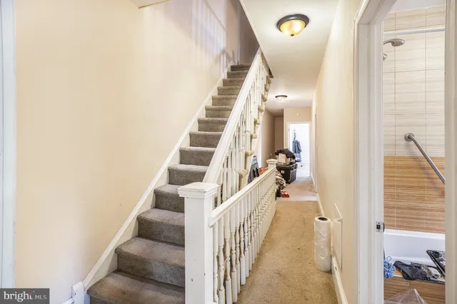 a view of a hallway with wooden floor and entryway