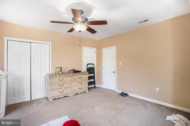 a view of a bedroom with cabinet cabinet cabinet and a chandelier fan