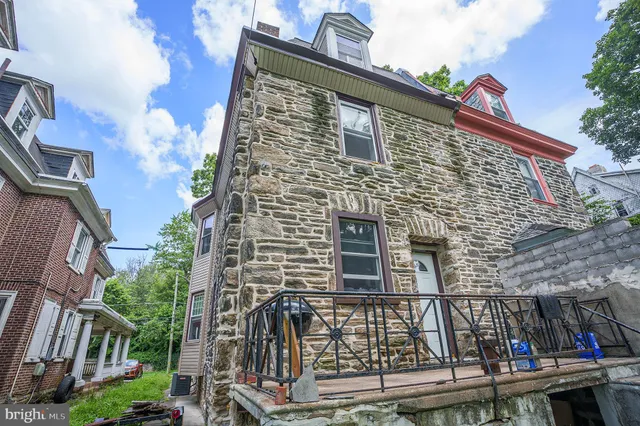 a front view of a house with plants