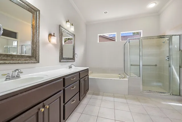 a spacious bathroom with a tub sink shower and mirror