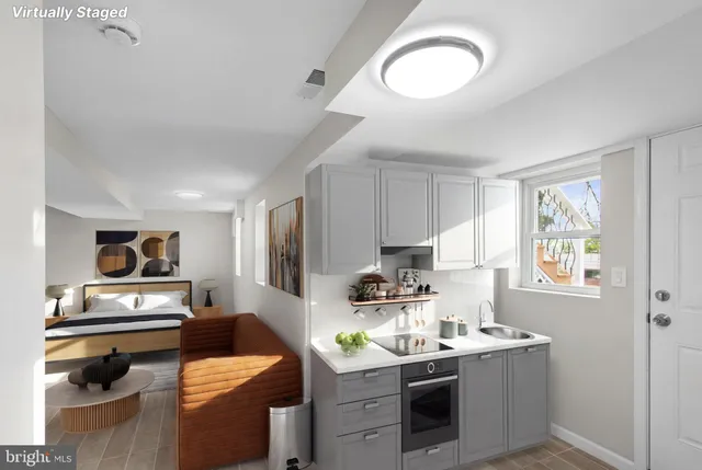 a kitchen with stainless steel appliances a stove a sink and a refrigerator