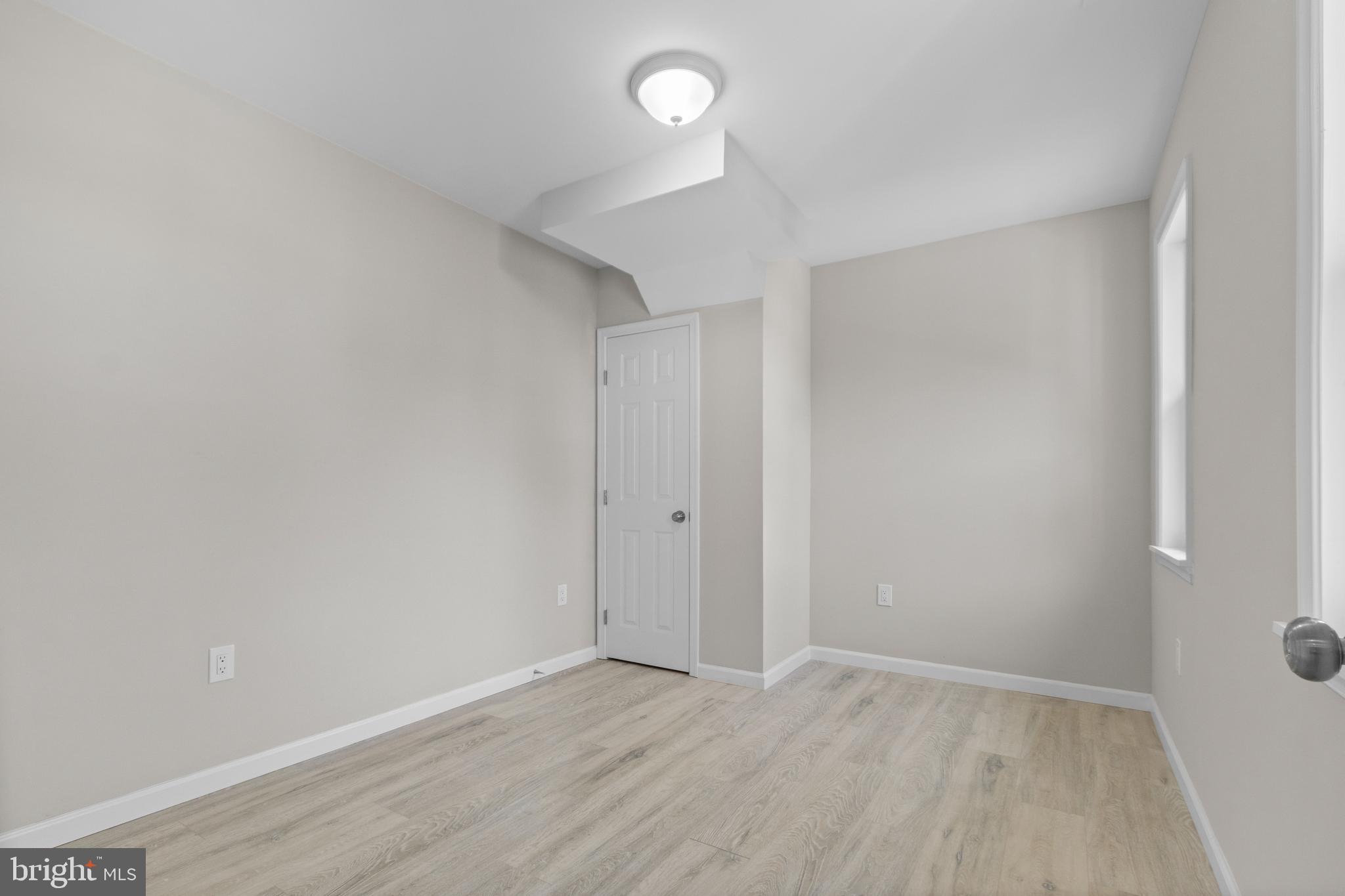 5021 A Street Southeast Washington, DC 20019 - Photo 12 of 43 a view of an empty room with wooden floor and a window