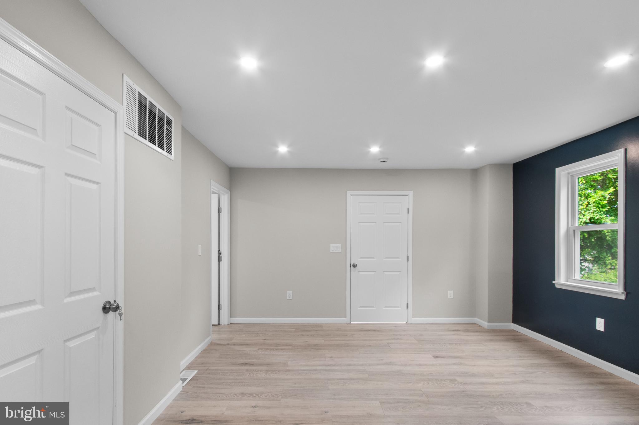 5021 A Street Southeast Washington, DC 20019 - Photo 17 of 43 a view of an empty room with wooden floor and a window