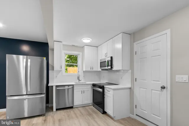 a kitchen with a refrigerator and a sink
