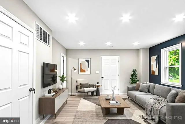 a living room with furniture and a flat screen tv