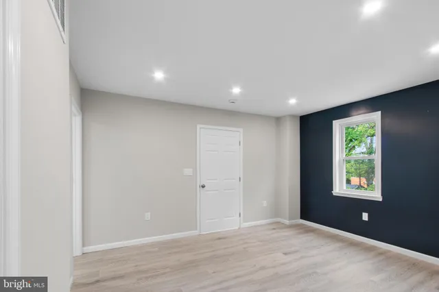 an empty room with windows and closet