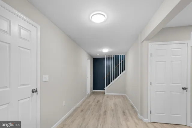 a view of hallway with stairs and wooden floor