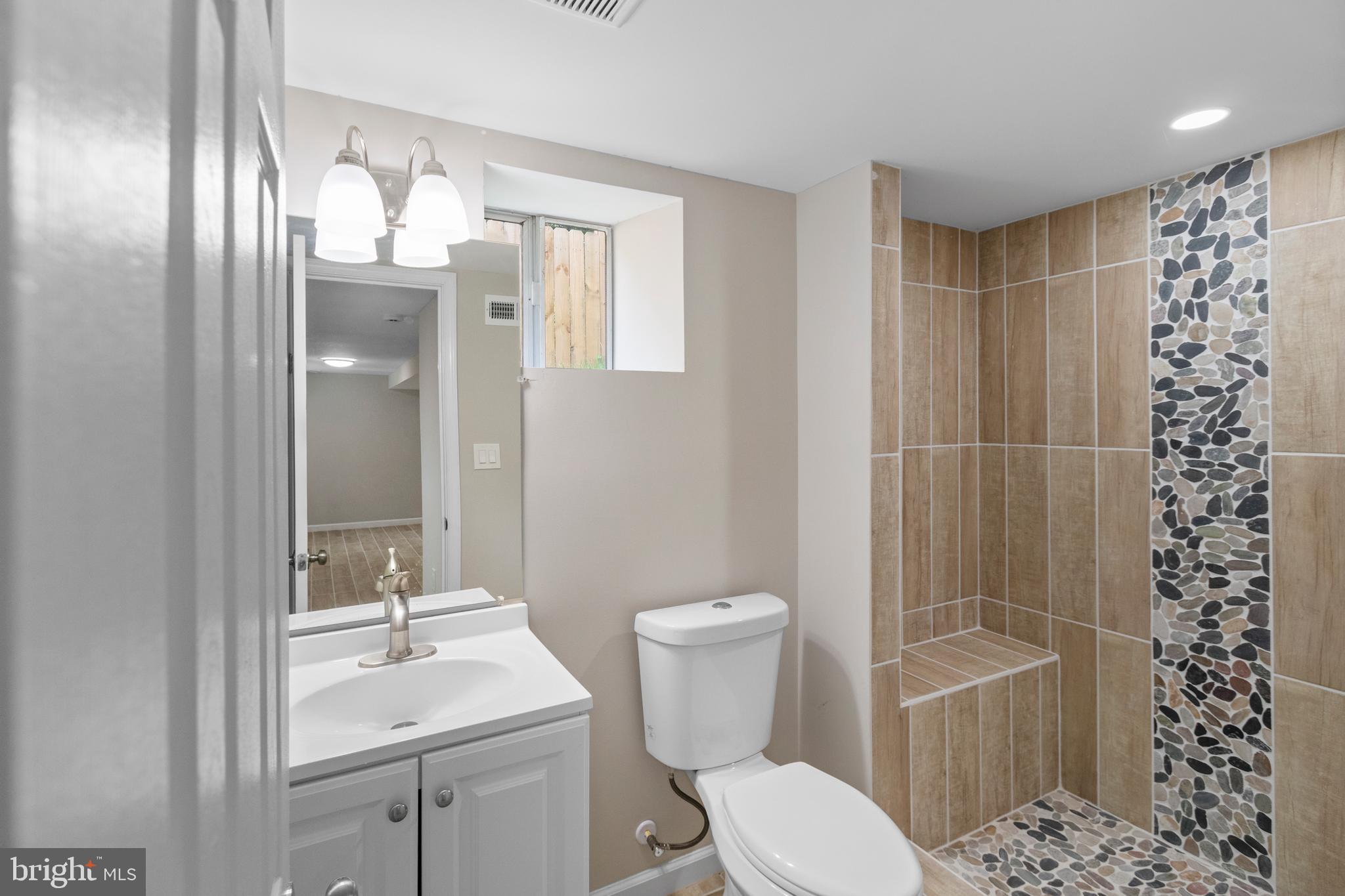 5021 A Street Southeast Washington, DC 20019 - Photo 33 of 43 a bathroom with a toilet a sink and shower