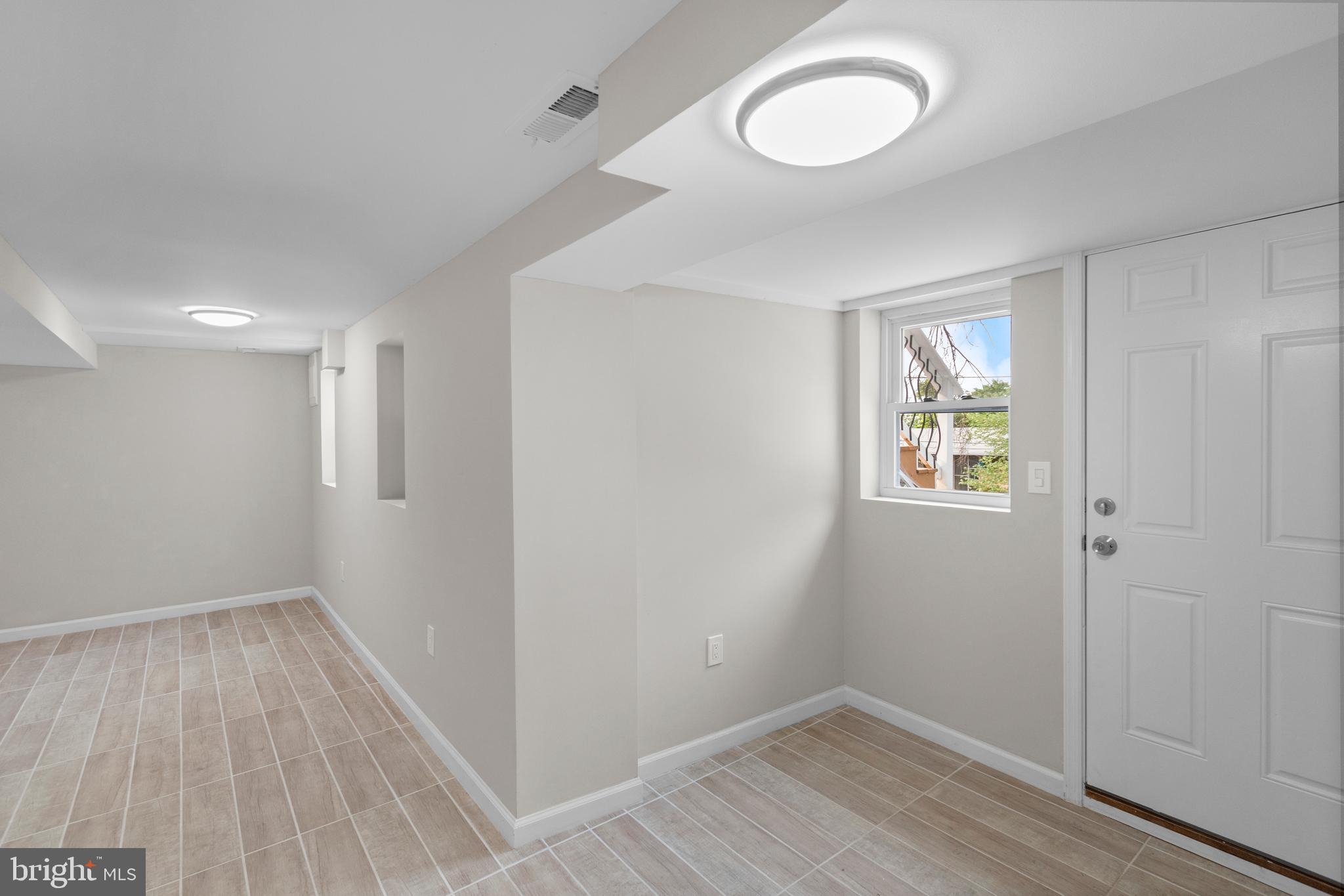 5021 A Street Southeast Washington, DC 20019 - Photo 36 of 43 an empty room with wooden floor and windows